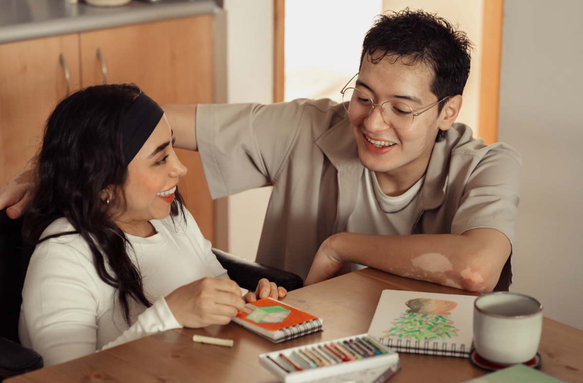 Two people talking at a table.