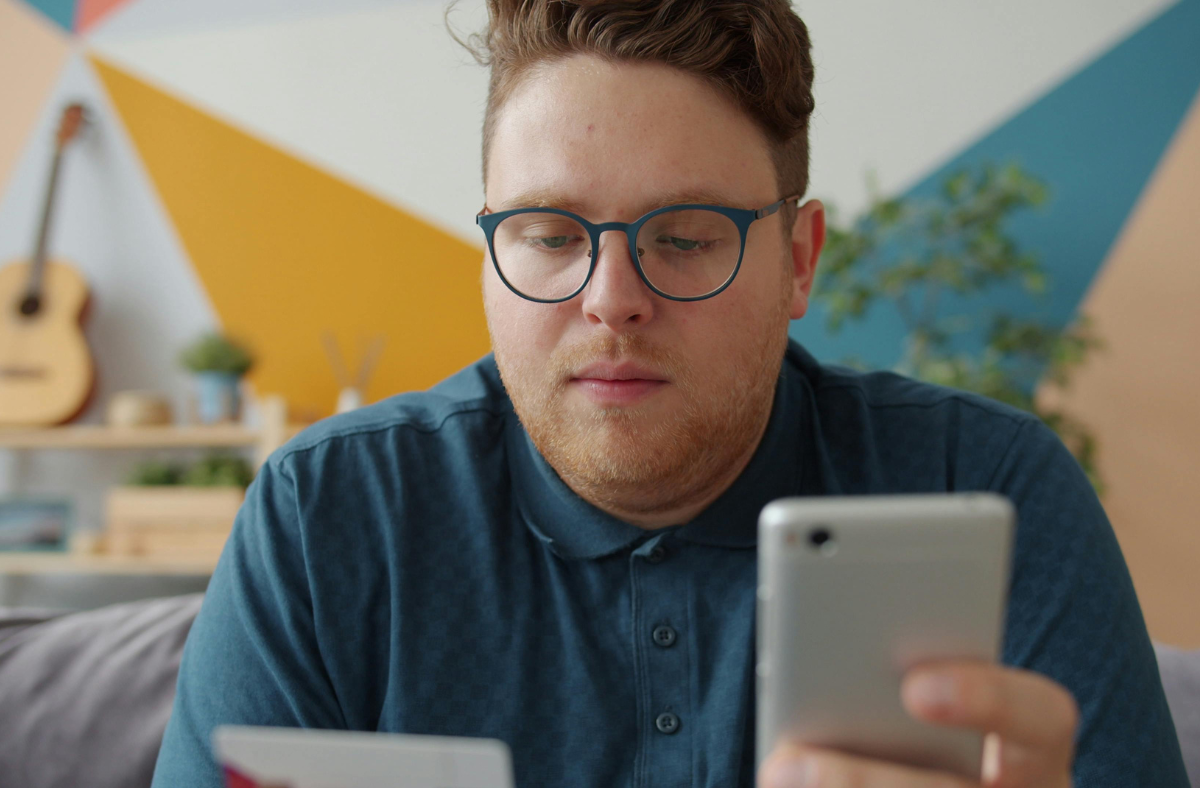 A person looking at their phone, concerned.