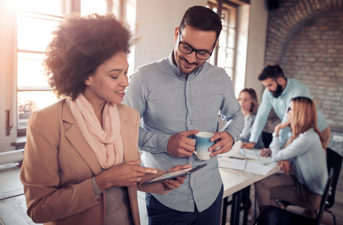 Two people in office looking at tablet