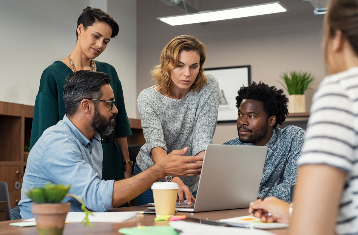 People huddled around a computer